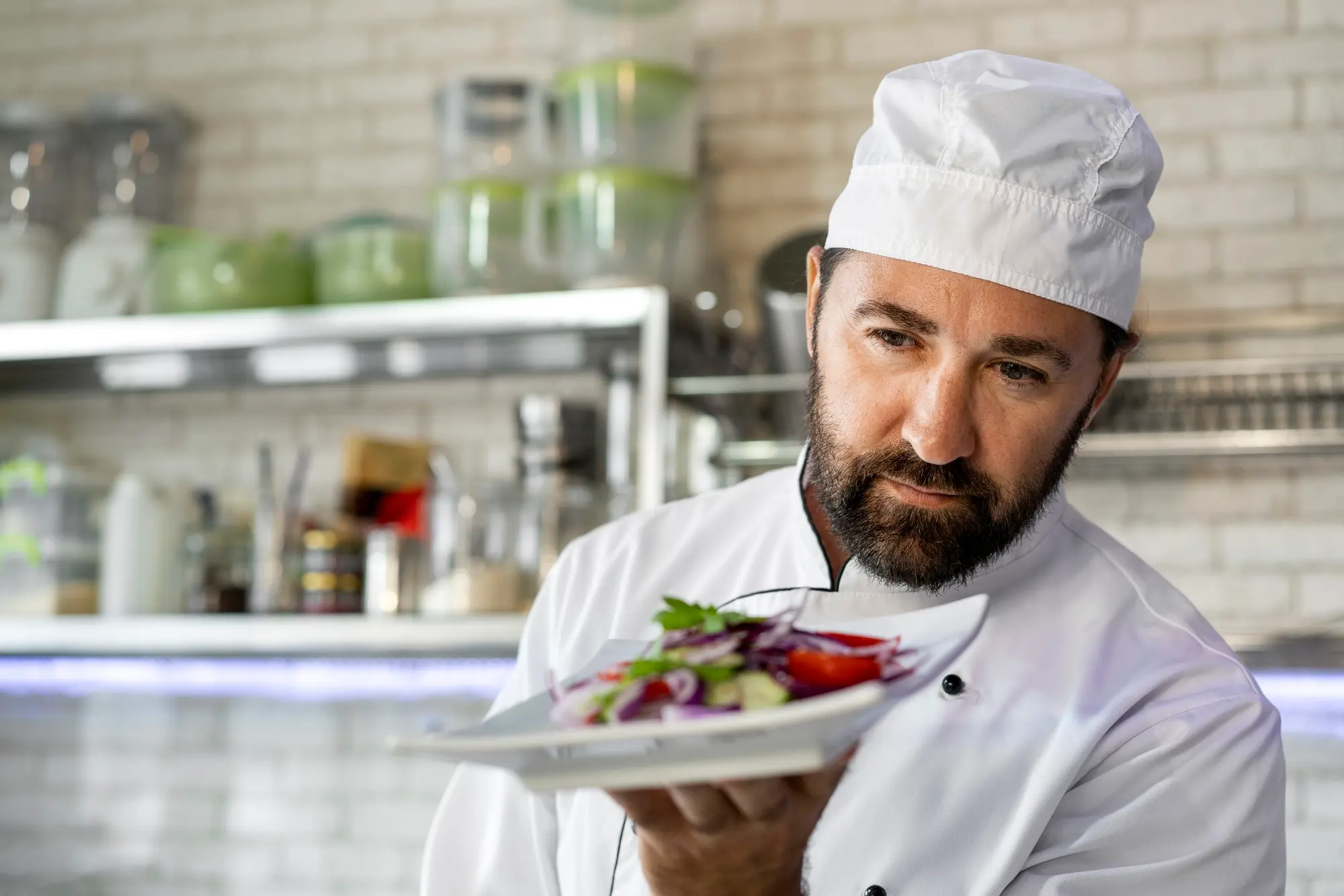 Male Chef Kitchen Holding Plate Salad - Ello Gestão Contábil